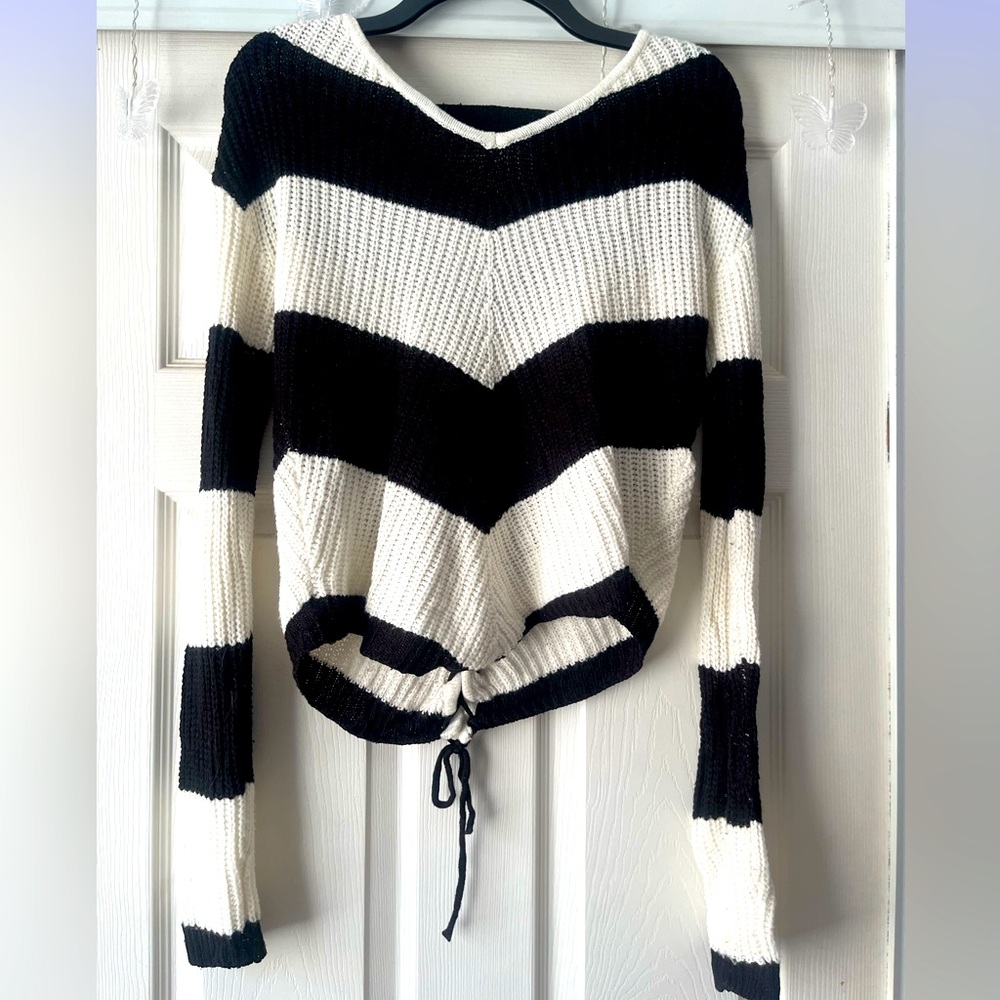 Black and white sweater with tie in back.